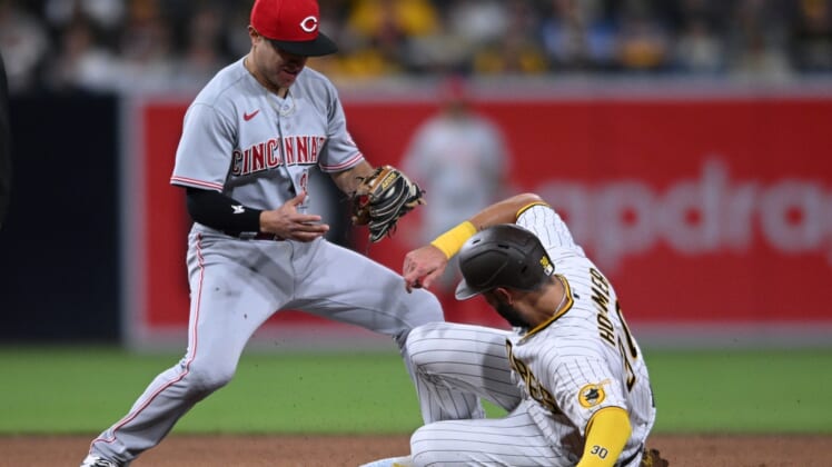 Apr 19, 2022; San Diego, California, USA; San Diego Padres first baseman Eric Hosmer (30) advances to second base on a wild pitch ahead of the tag by Cincinnati Reds second baseman Alejo Lopez (left) during the fourth inning at Petco Park. Mandatory Credit: Orlando Ramirez-USA TODAY Sports