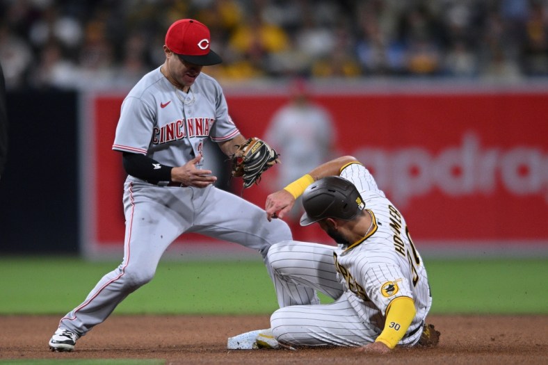 Apr 19, 2022; San Diego, California, USA; San Diego Padres first baseman Eric Hosmer (30) advances to second base on a wild pitch ahead of the tag by Cincinnati Reds second baseman Alejo Lopez (left) during the fourth inning at Petco Park. Mandatory Credit: Orlando Ramirez-USA TODAY Sports