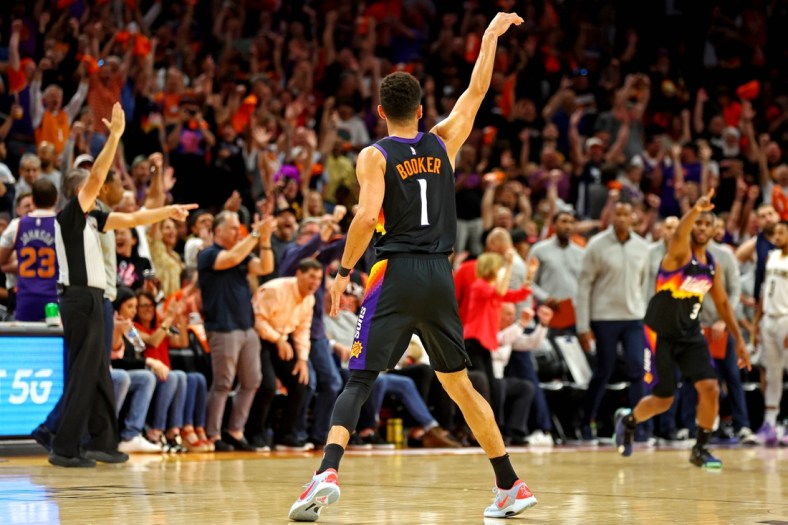 Apr 19, 2022; Phoenix, Arizona, USA; Phoenix Suns guard Devin Booker (1) reacts after a play during the second quarter against the New Orleans Pelicans during game one of the first round for the 2022 NBA playoffs at Footprint Center. Mandatory Credit: Mark J. Rebilas-USA TODAY Sports