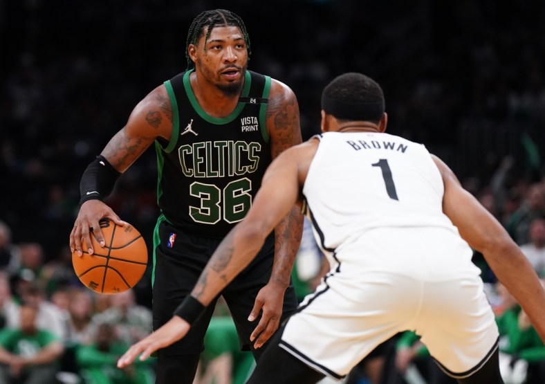 Apr 17, 2022; Boston, Massachusetts, USA; Boston Celtics guard Marcus Smart (36) looks for an opening against Brooklyn Nets forward Bruce Brown (1) in the second half during game one of the first round for the 2022 NBA playoffs at TD Garden. Mandatory Credit: David Butler II-USA TODAY Sports