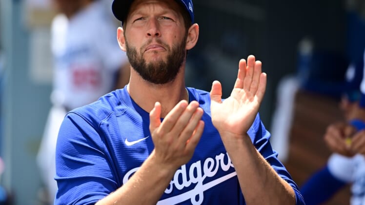 Apr 20, 2022; Los Angeles, California, USA;  Los Angeles Dodgers starting pitcher Clayton Kershaw (22) cheers in the dugout before the start of the game against the Atlanta Braves at Dodger Stadium. Mandatory Credit: Jayne Kamin-Oncea-USA TODAY Sports