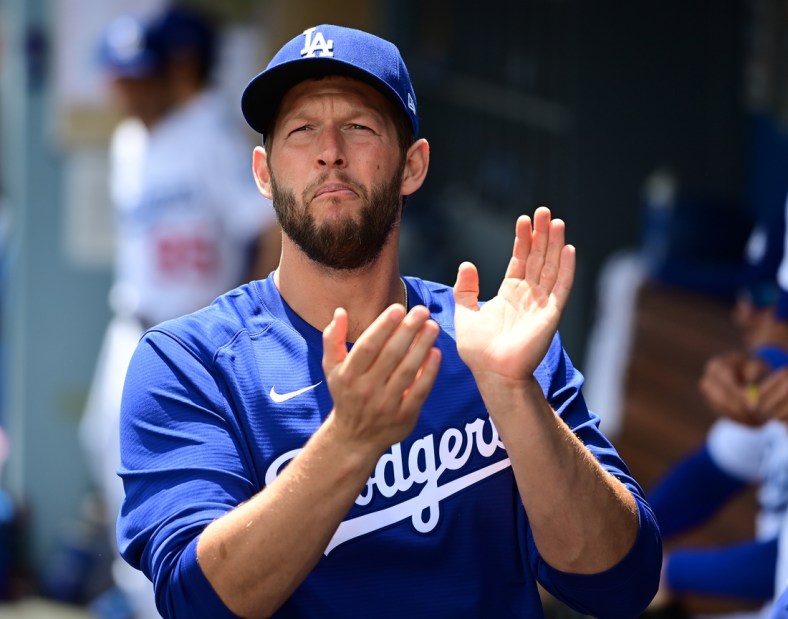 Apr 20, 2022; Los Angeles, California, USA;  Los Angeles Dodgers starting pitcher Clayton Kershaw (22) cheers in the dugout before the start of the game against the Atlanta Braves at Dodger Stadium. Mandatory Credit: Jayne Kamin-Oncea-USA TODAY Sports