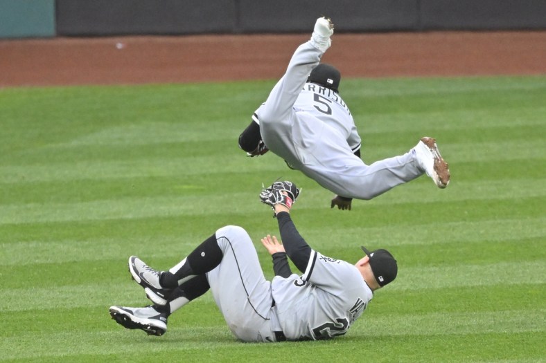Apr 20, 2022; Cleveland, Ohio, USA; Chicago White Sox third baseman Josh Harrison (5) makes a running catch while colliding with left fielder Andrew Vaughn (25) in the fifth inning against the Cleveland Guardians at Progressive Field. Mandatory Credit: David Richard-USA TODAY Sports