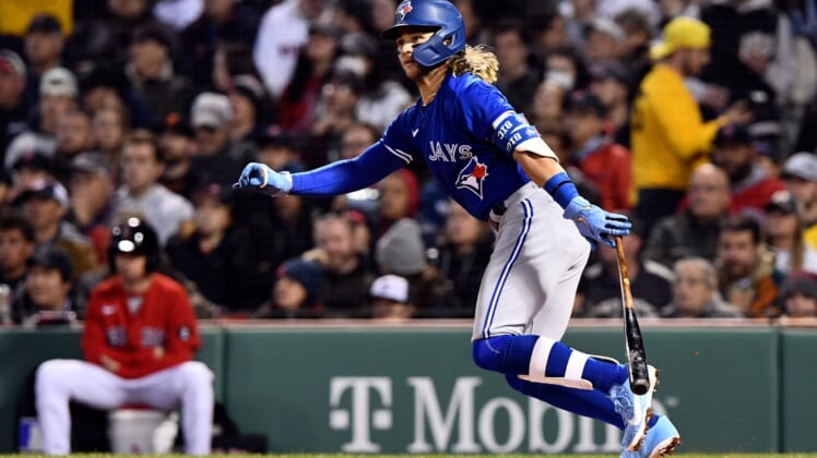 Apr 20, 2022; Boston, Massachusetts, USA; Toronto Blue Jays shortstop Bo Bichette (11) watches the ball after hitting a two-run RBI against the Boston Red Sox during the second inning at Fenway Park. Mandatory Credit: Brian Fluharty-USA TODAY Sports