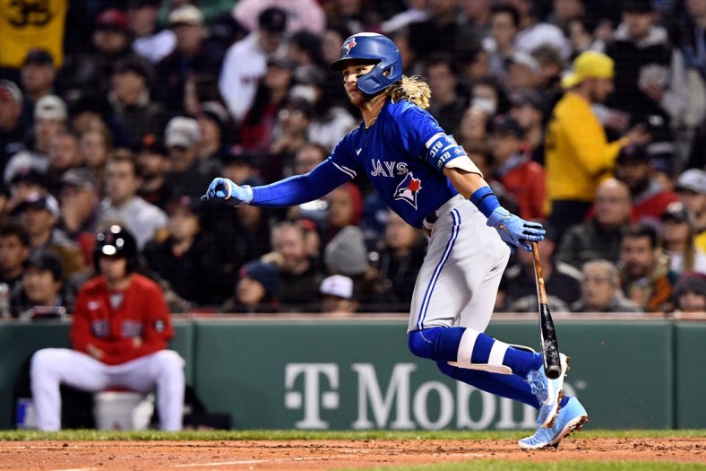 Apr 20, 2022; Boston, Massachusetts, USA; Toronto Blue Jays shortstop Bo Bichette (11) watches the ball after hitting a two-run RBI against the Boston Red Sox during the second inning at Fenway Park. Mandatory Credit: Brian Fluharty-USA TODAY Sports
