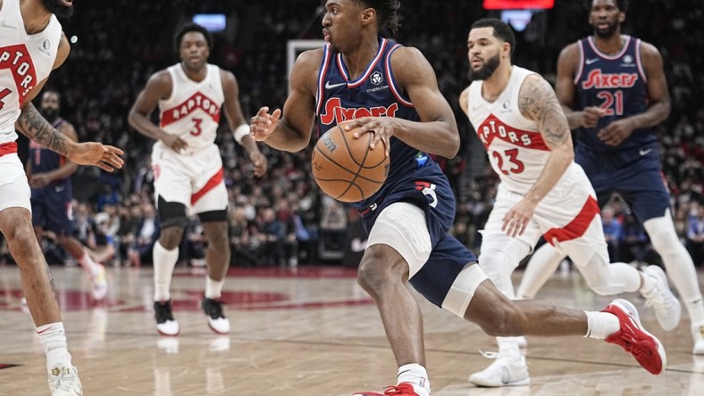 Apr 20, 2022; Toronto, Ontario, CAN; Philadelphia 76ers guard Tyrese Maxey (0) dribbles to the basket past Toronto Raptors guard Fred VanVleet (23) during the first half of game three of the first round for the 2022 NBA playoffs at Scotiabank Arena. Mandatory Credit: John E. Sokolowski-USA TODAY Sports