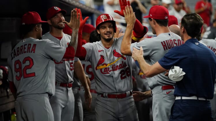 Apr 20, 2022; Miami, Florida, USA; St. Louis Cardinals third baseman Nolan Arenado (28) celebrates his two run home run in the ninth inning of the game against the Miami Marlins with teammates in the dugout at loanDepot park. Mandatory Credit: Jasen Vinlove-USA TODAY Sports