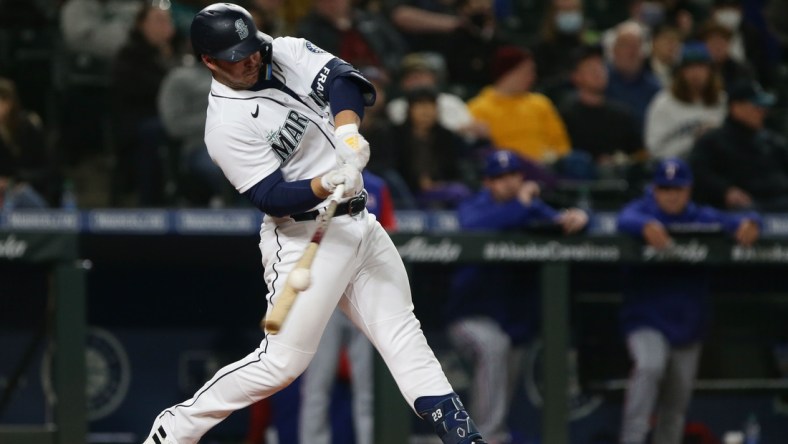 Apr 20, 2022; Seattle, Washington, USA; Seattle Mariners third baseman Ty France (23) hits an RBI single against the Texas Rangers during the fifth inning at T-Mobile Park. Mandatory Credit: Lindsey Wasson-USA TODAY Sports