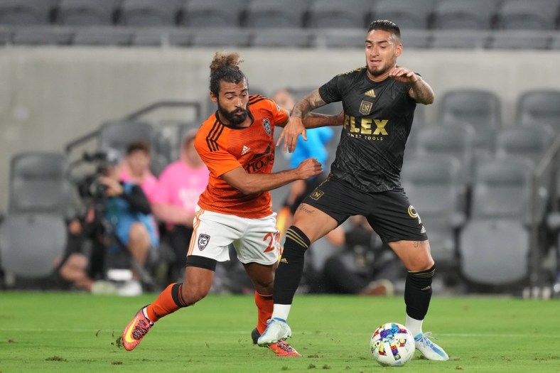 Apr 20, 2022; Los Angeles, California, USA; LAFC forward Cristian Arango (9) and Orange County SC defender Danny Acosta (24) battle for the ball in the second half at Banc of California Stadium. Mandatory Credit: Kirby Lee-USA TODAY Sports