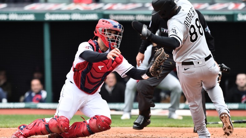 Apr 21, 2022; Cleveland, Ohio, USA; Cleveland Guardians catcher Austin Hedges (17) tags out Chicago White Sox center fielder Luis Robert (88) during the fourth inning at Progressive Field. Mandatory Credit: Ken Blaze-USA TODAY Sports