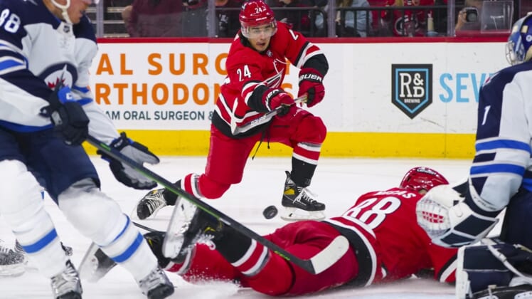 Apr 21, 2022; Raleigh, North Carolina, USA;  Carolina Hurricanes center Seth Jarvis (24) takes a shot against the Winnipeg Jets during the first period at PNC Arena. Mandatory Credit: James Guillory-USA TODAY Sports