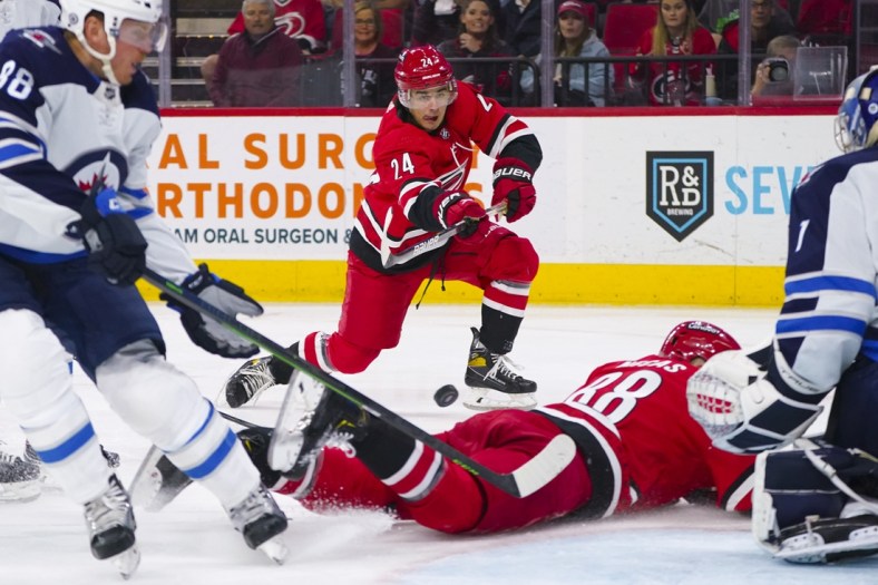 Apr 21, 2022; Raleigh, North Carolina, USA;  Carolina Hurricanes center Seth Jarvis (24) takes a shot against the Winnipeg Jets during the first period at PNC Arena. Mandatory Credit: James Guillory-USA TODAY Sports