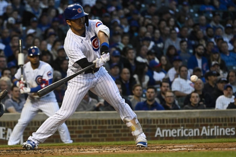 Apr 21, 2022; Chicago, Illinois, USA;  Chicago Cubs right fielder Seiya Suzuki (27) hits an RBI during the second inning against the Pittsburgh Pirates at Wrigley Field. Mandatory Credit: Matt Marton-USA TODAY Sports