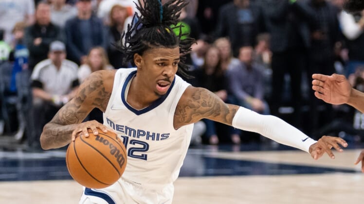 Apr 21, 2022; Minneapolis, Minnesota, USA; Memphis Grizzlies guard Ja Morant (12) dribbles against the Minnesota Timberwolves in the second quarter during game one of the three round for the 2022 NBA playoffs at Target Center. Mandatory Credit: Brad Rempel-USA TODAY Sports
