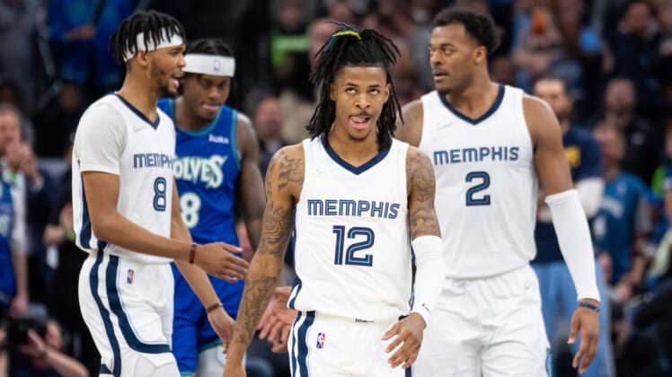 Apr 21, 2022; Minneapolis, Minnesota, USA; Memphis Grizzlies guard Ja Morant (12) walks back onto the court against the Minnesota Timberwolves in the third quarter during game one of the three round for the 2022 NBA playoffs at Target Center. Mandatory Credit: Brad Rempel-USA TODAY Sports