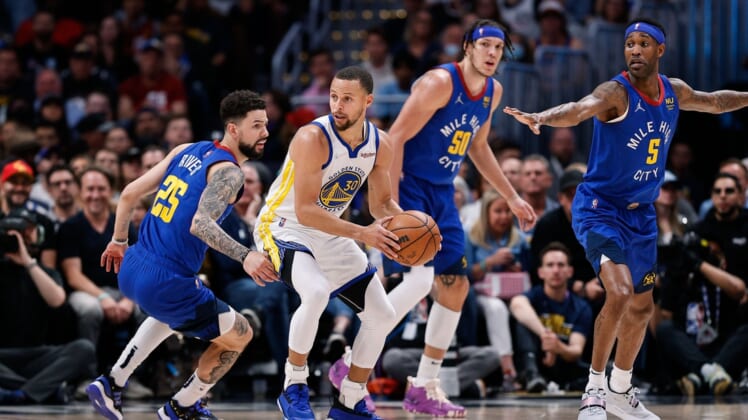 Apr 21, 2022; Denver, Colorado, USA; Golden State Warriors guard Stephen Curry (30) controls the ball as Denver Nuggets guard Austin Rivers (25) and forward Aaron Gordon (50) and forward Will Barton (5) defend in the first quarter during game three of the first round for the 2022 NBA playoffs at Ball Arena. Mandatory Credit: Isaiah J. Downing-USA TODAY Sports