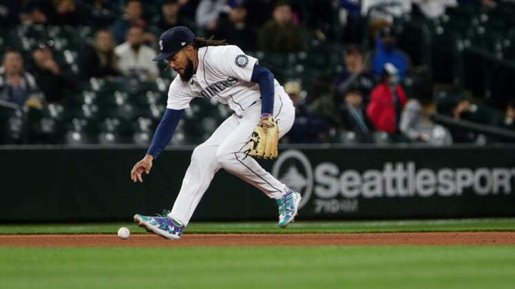 Apr 21, 2022; Seattle, Washington, USA;  Seattle Mariners shortstop J.P. Crawford (3) commits a fielding error during the fifth inning against the Texas Rangers at T-Mobile Park. Mandatory Credit: Lindsey Wasson-USA TODAY Sports