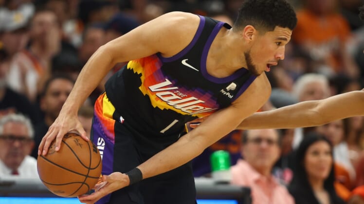 Apr 19, 2022; Phoenix, Arizona, USA; Phoenix Suns guard Devin Booker (1) against the New Orleans Pelicans during game two of the first round for the 2022 NBA playoffs at Footprint Center. Mandatory Credit: Mark J. Rebilas-USA TODAY Sports