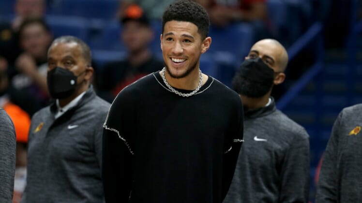 Apr 22, 2022; New Orleans, Louisiana, USA; Injured Phoenix Suns guard Devin Booker watches in the second half of game three of the first round for the 2022 NBA playoffs at the Smoothie King Center against the New Orleans Pelicans. The Suns won, 114-111. Mandatory Credit: Chuck Cook-USA TODAY Sports