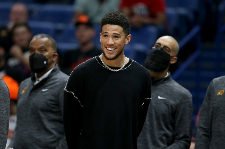Apr 22, 2022; New Orleans, Louisiana, USA; Injured Phoenix Suns guard Devin Booker watches in the second half of game three of the first round for the 2022 NBA playoffs at the Smoothie King Center against the New Orleans Pelicans. The Suns won, 114-111. Mandatory Credit: Chuck Cook-USA TODAY Sports