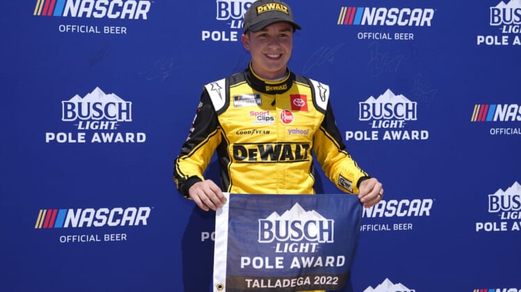 Apr 23, 2022; Talladega, Alabama, USA; NASCAR Cup Series driver Christopher Bell (20) poses for a picture after winning the pole for the GEICO 500 at Talladega Superspeedway. Mandatory Credit: Jasen Vinlove-USA TODAY Sports