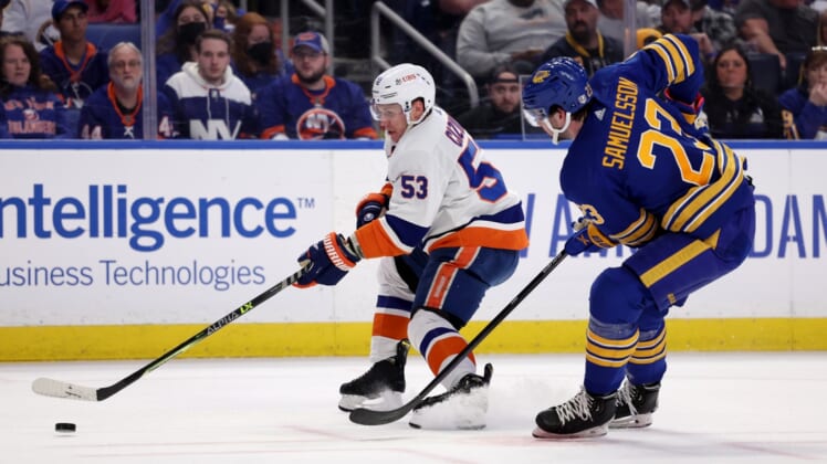 Apr 23, 2022; Buffalo, New York, USA;  New York Islanders center Casey Cizikas (53) skates with the puck as Buffalo Sabres defenseman Mattias Samuelsson (23) defends during the first period at KeyBank Center. Mandatory Credit: Timothy T. Ludwig-USA TODAY Sports