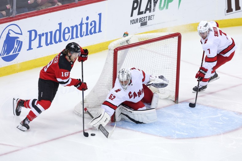 Apr 23, 2022; Newark, New Jersey, USA; Carolina Hurricanes goaltender Pyotr Kochetkov (52) stops the puck against  New Jersey Devils center Dawson Mercer (18) during the second period at Prudential Center. Mandatory Credit: Vincent Carchietta-USA TODAY Sports