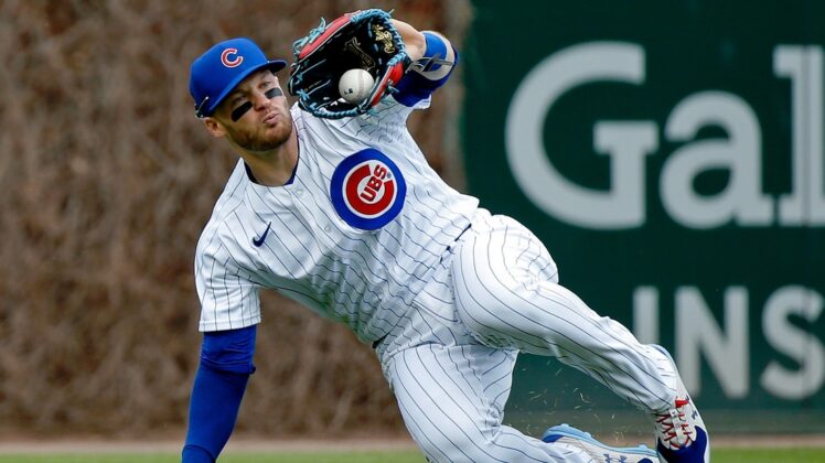 Apr 23, 2022; Chicago, Illinois, USA; Chicago Cubs left fielder Ian Happ (8) makes a catch for an out on a fly ball hit by Pittsburgh Pirates third baseman Michael Chavis (not pictured) during the first inning at Wrigley Field. Mandatory Credit: Jon Durr-USA TODAY Sports