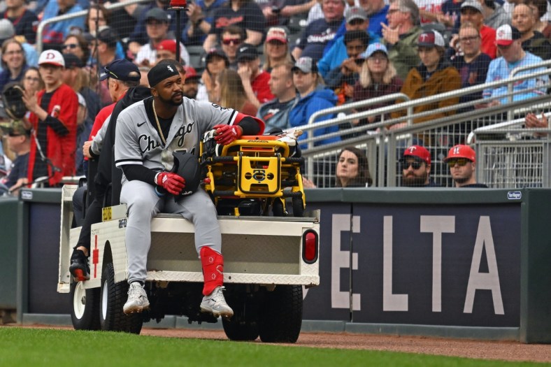 Apr 23, 2022; Minneapolis, Minnesota, USA;  Chicago White Sox left fielder Eloy Jimenez (74) is carted off the field after being injured running to first on a ground ball against the Minnesota Twins during the second inning at Target Field. Mandatory Credit: Nick Wosika-USA TODAY Sports