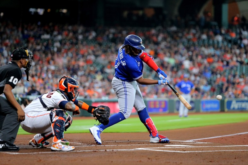 Apr 23, 2022; Houston, Texas, USA; Toronto Blue Jays first baseman Vladimir Guerrero Jr. (27) hits a single to left field against the Houston Astros during the first inning at Minute Maid Park. Mandatory Credit: Erik Williams-USA TODAY Sports