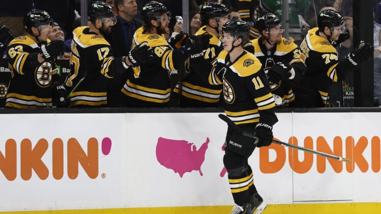 Apr 23, 2022; Boston, Massachusetts, USA; Boston Bruins center Trent Frederic (11) is congratulated at the bench after scoring against the New York Rangers during the third period at TD Garden. Mandatory Credit: Winslow Townson-USA TODAY Sports