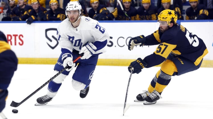 Apr 23, 2022; Tampa, Florida, USA; Tampa Bay Lightning center Brayden Point (21) skates with the puck as Nashville Predators defenseman Dante Fabbro (57) defends during the first period at Amalie Arena. Mandatory Credit: Kim Klement-USA TODAY Sports