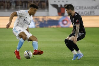 Apr 23, 2022; Washington, District of Columbia, USA; New England Revolution midfielder Brandon Bye (15) dribbles the ball as D.C. United defender Steve Birnbaum (15) defends in the first half at Audi Field. Mandatory Credit: Geoff Burke-USA TODAY Sports