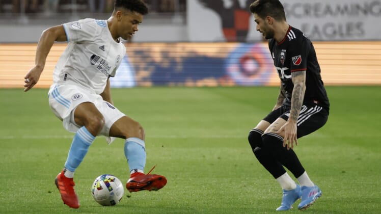Apr 23, 2022; Washington, District of Columbia, USA; New England Revolution midfielder Brandon Bye (15) dribbles the ball as D.C. United defender Steve Birnbaum (15) defends in the first half at Audi Field. Mandatory Credit: Geoff Burke-USA TODAY Sports