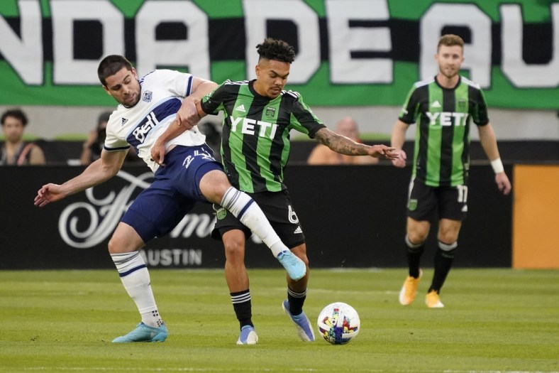 Apr 23, 2022; Austin, Texas, USA; Vancouver Whitecaps forward Brian White (24) and Austin FC midfielder Daniel Pereira (6) battle for the ball in the first half of their match at Q2 Stadium. Mandatory Credit: Scott Wachter-USA TODAY Sports
