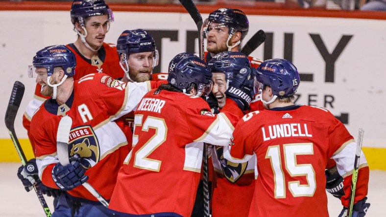 Apr 23, 2022; Sunrise, Florida, USA; Florida Panthers defenseman Brandon Montour, center, celebrates with defenseman MacKenzie Weegar (52) after scoring the winning goal during overtime against the Toronto Maple Leafs at FLA Live Arena. Mandatory Credit: Sam Navarro-USA TODAY Sports