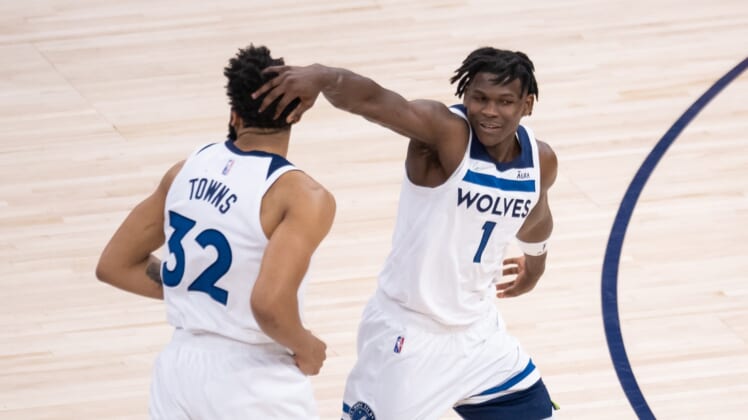 Apr 23, 2022; Minneapolis, Minnesota, USA; Minnesota Timberwolves forward Anthony Edwards (1) congratulates center Karl-Anthony Towns (32) against the Memphis Grizzlies in the first quarter during game four of the first round for the 2022 NBA playoffs at Target Center. Mandatory Credit: Brad Rempel-USA TODAY Sports