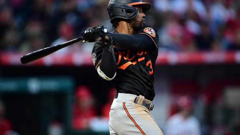 Apr 23, 2022; Anaheim, California, USA; Baltimore Orioles center fielder Cedric Mullins (31) hits a single against the Los Angeles Angels during the fifth inning at Angel Stadium. Mandatory Credit: Gary A. Vasquez-USA TODAY Sports