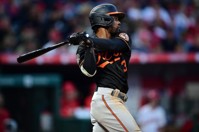 Apr 23, 2022; Anaheim, California, USA; Baltimore Orioles center fielder Cedric Mullins (31) hits a single against the Los Angeles Angels during the fifth inning at Angel Stadium. Mandatory Credit: Gary A. Vasquez-USA TODAY Sports