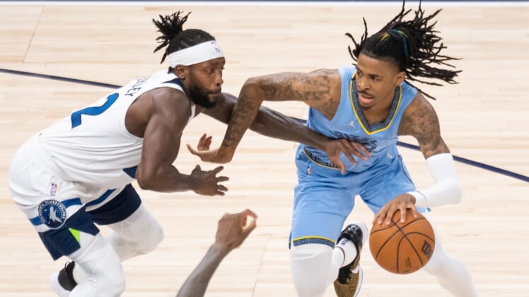 Apr 23, 2022; Minneapolis, Minnesota, USA; Memphis Grizzlies guard Ja Morant (12) dribbles against the Minnesota Timberwolves guard Patrick Beverley (22) in the fourth quarter during game four of the first round for the 2022 NBA playoffs at Target Center. Mandatory Credit: Brad Rempel-USA TODAY Sports