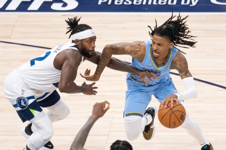 Apr 23, 2022; Minneapolis, Minnesota, USA; Memphis Grizzlies guard Ja Morant (12) dribbles against the Minnesota Timberwolves guard Patrick Beverley (22) in the fourth quarter during game four of the first round for the 2022 NBA playoffs at Target Center. Mandatory Credit: Brad Rempel-USA TODAY Sports