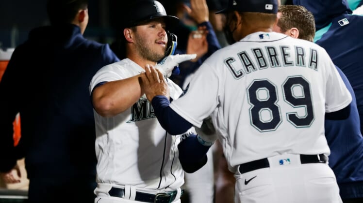 Apr 23, 2022; Seattle, Washington, USA;  Seattle Mariners first baseman Ty France (23) is greeted by batting practice pitcher Nasusel Cabrera (89) after hitting a three-run home run against the Kansas City Royals at T-Mobile Park. Mandatory Credit: Lindsey Wasson-USA TODAY Sports