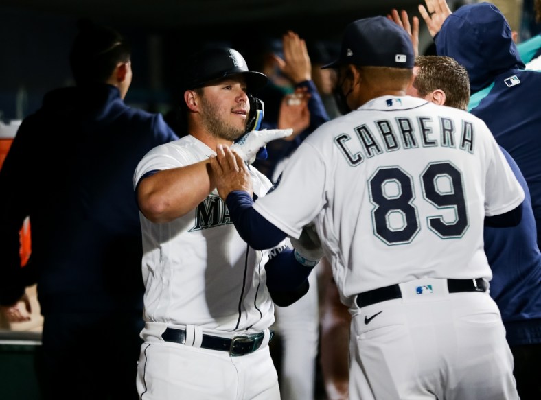 Apr 23, 2022; Seattle, Washington, USA;  Seattle Mariners first baseman Ty France (23) is greeted by batting practice pitcher Nasusel Cabrera (89) after hitting a three-run home run against the Kansas City Royals at T-Mobile Park. Mandatory Credit: Lindsey Wasson-USA TODAY Sports