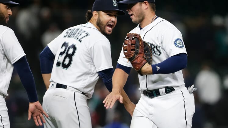 Apr 23, 2022; Seattle, Washington, USA; Seattle Mariners third baseman Eugenio Suarez (28) greets first baseman Ty France (23) as they celebrate a 13-7 win at T-Mobile Park. Mandatory Credit: Lindsey Wasson-USA TODAY Sports