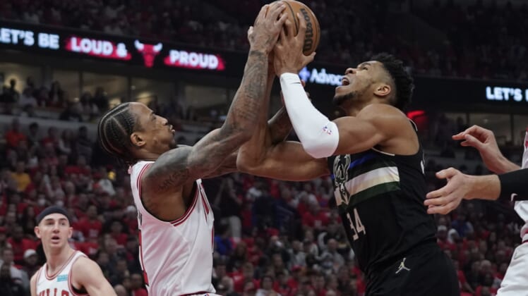 Apr 24, 2022; Chicago, Illinois, USA; Chicago Bulls forward DeMar DeRozan (11) and Milwaukee Bucks forward Giannis Antetokounmpo (34) go for the ball in the first half during game four of the first round for the 2022 NBA playoffs at United Center. Mandatory Credit: David Banks-USA TODAY Sports