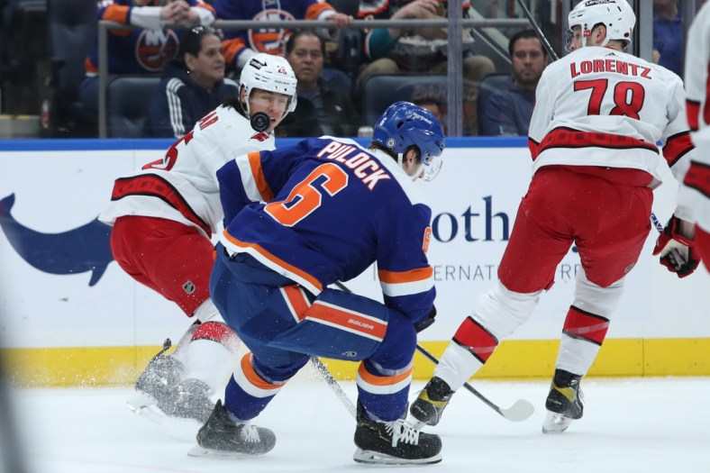 Apr 24, 2022; Elmont, New York, USA; Carolina Hurricanes center Seth Jarvis (24) tracks the puck while New York Islanders defenseman Ryan Pulock (6) defends during the first period at UBS Arena. Mandatory Credit: Thomas Salus-USA TODAY Sports