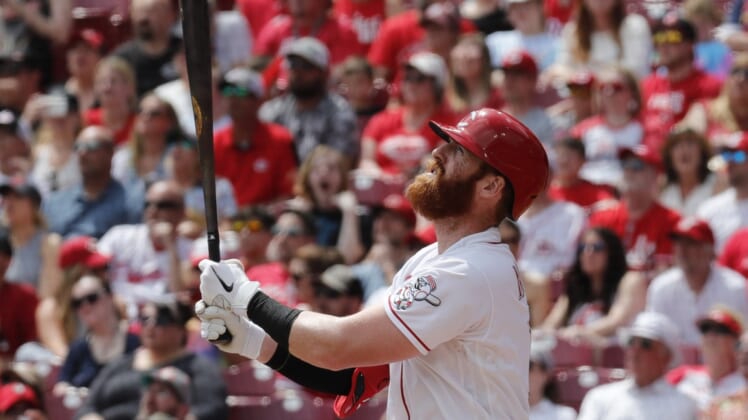 Apr 24, 2022; Cincinnati, Ohio, USA; Cincinnati Reds designated hitter Colin Moran (16) hits a sacrifice fly against the St. Louis Cardinals during the first inning at Great American Ball Park. Mandatory Credit: David Kohl-USA TODAY Sports
