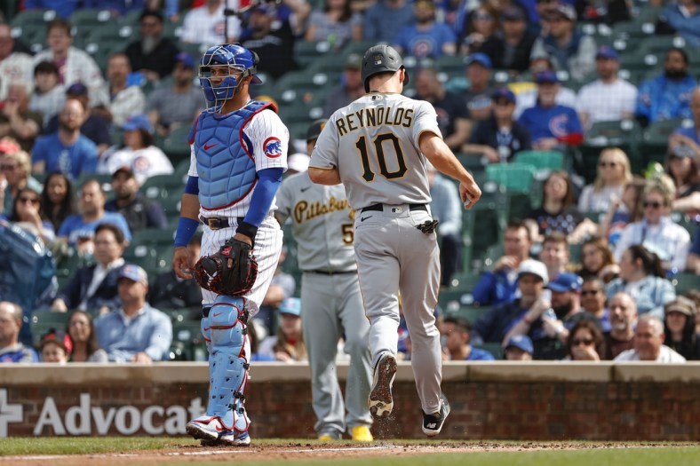 Apr 24, 2022; Chicago, Illinois, USA; Pittsburgh Pirates left fielder Bryan Reynolds (10) scores against the Chicago Cubs during the third inning at Wrigley Field. Mandatory Credit: Kamil Krzaczynski-USA TODAY Sports