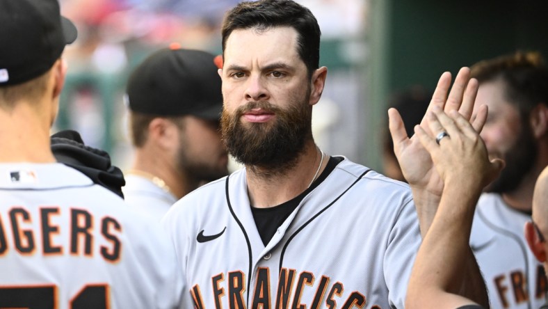 Apr 24, 2022; Washington, District of Columbia, USA; San Francisco Giants first baseman Brandon Belt (9) is congratulated by teammates after scoring in the ninth inning against the Washington Nationals at Nationals Park. Mandatory Credit: Brad Mills-USA TODAY Sports