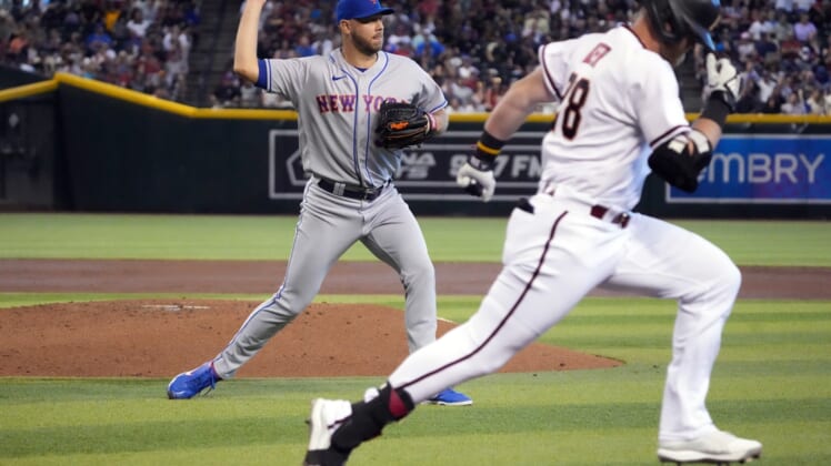 Apr 24, 2022; Phoenix, Arizona, USA; New York Mets starting pitcher Tylor Megill (38) throws out Arizona Diamondbacks designated hitter Seth Beer (28) at first base during the second inning at Chase Field. Mandatory Credit: Joe Camporeale-USA TODAY Sports